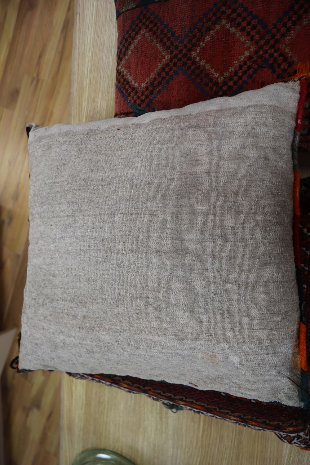 Three carpet cushions, pair 46 x 43cm, single 43 x 28cm